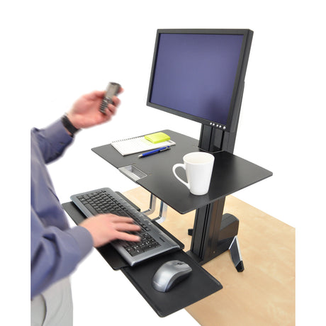 Person using a Ergotron Worksurface for WorkFit-S height-adjustable workstation